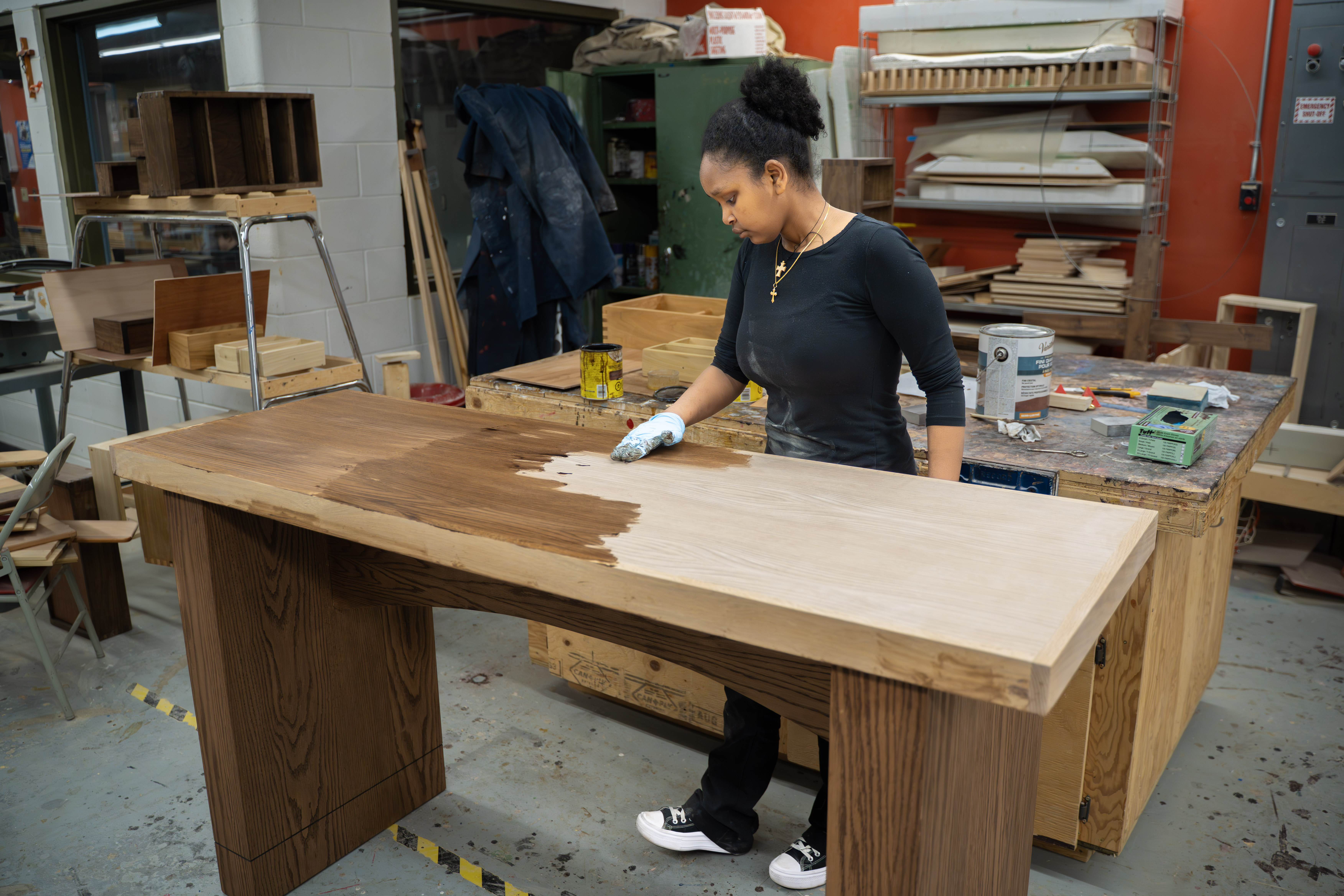 Student finishing a table in the Cabinetmaker Apprenticeship program